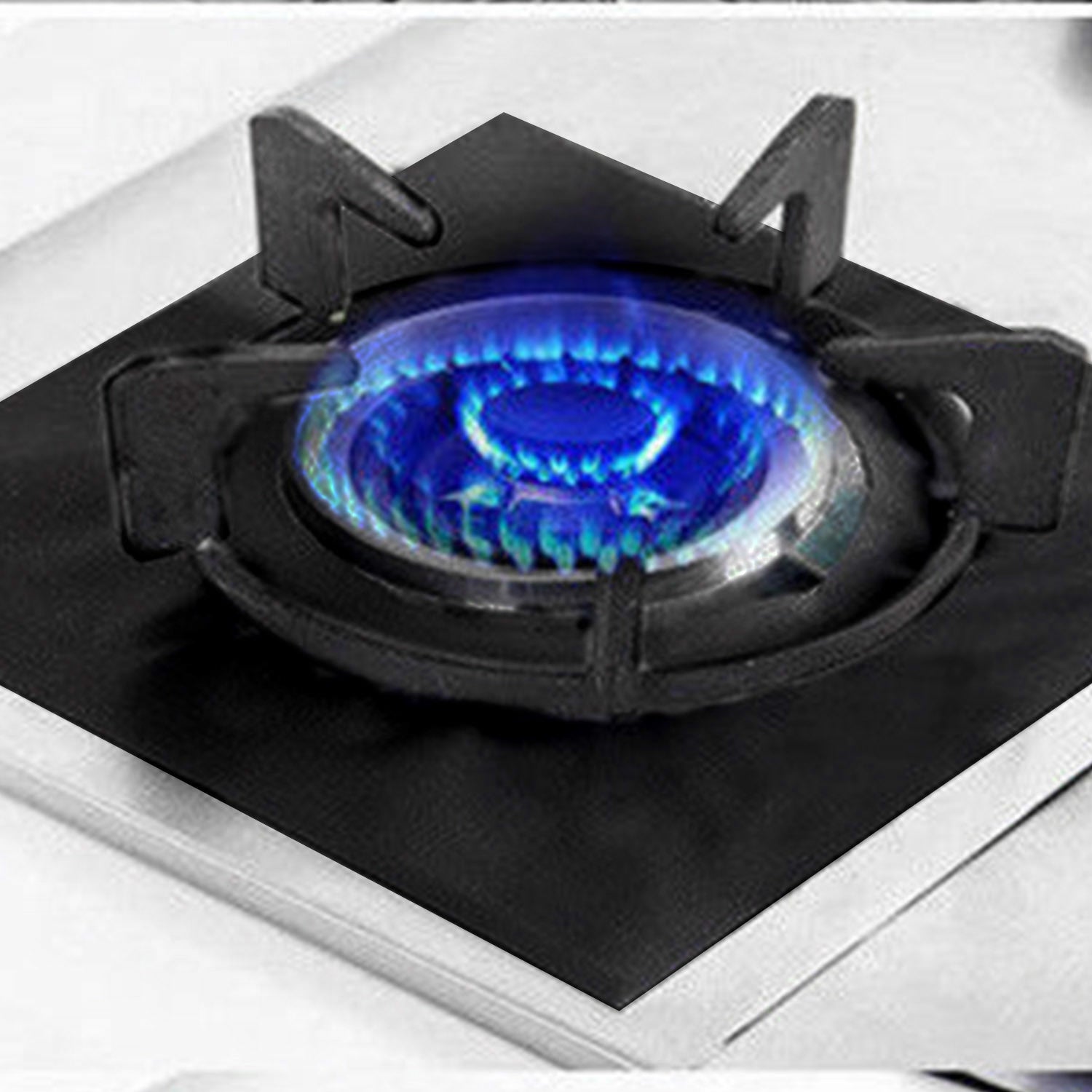 A stack of 4-Pack Reusable Nonstick Stovetop Burner Protector Liner papers with a white circle and crossing lines symbol in the center of the top sheet, treated with a PTFE coating.