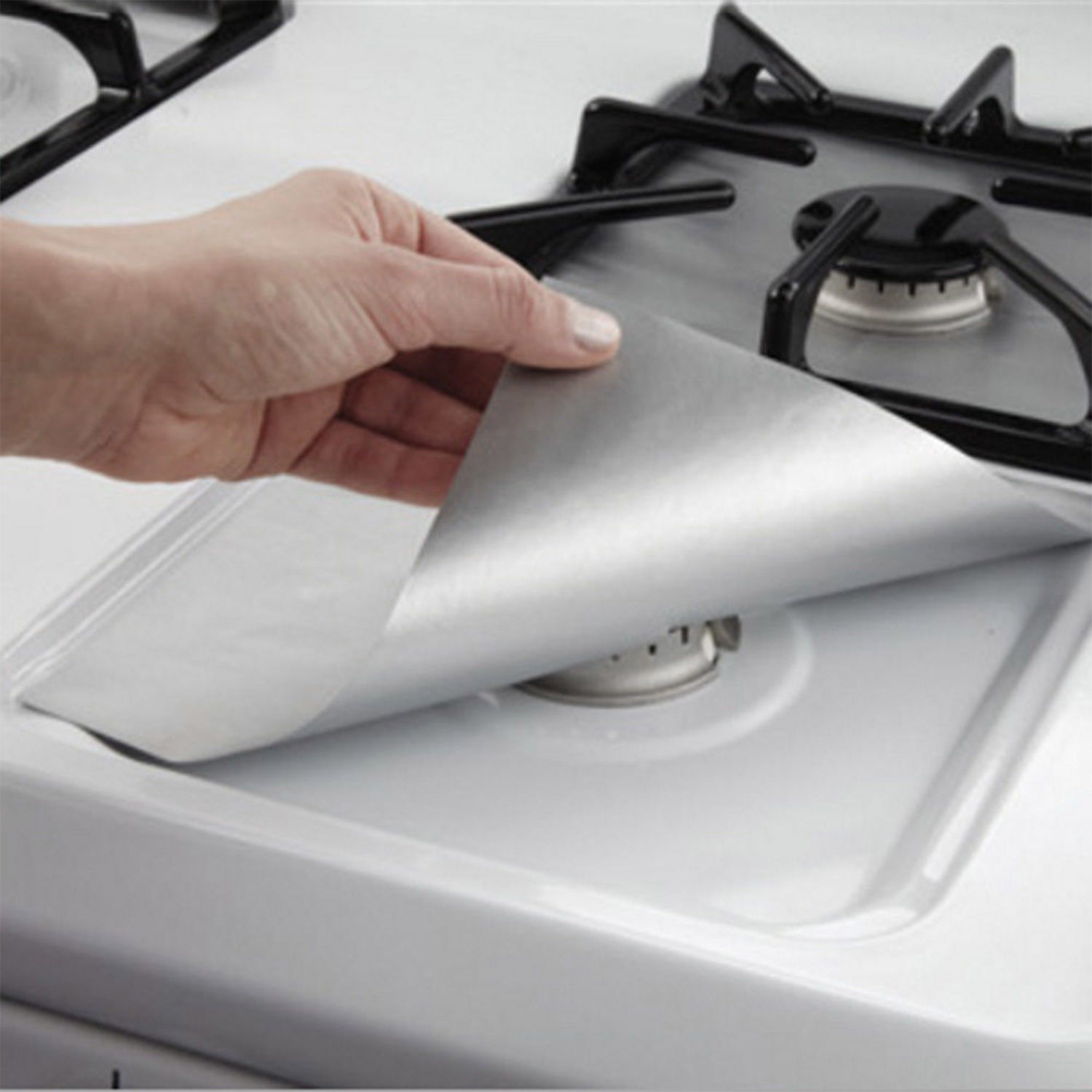 A stack of 4-Pack Reusable Nonstick Stovetop Burner Protector Liner papers with a white circle and crossing lines symbol in the center of the top sheet, treated with a PTFE coating.