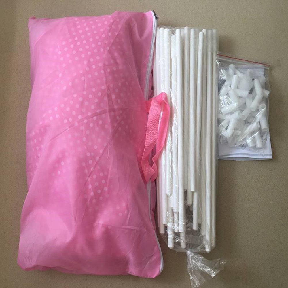 A purple children's Outdoor Indoor Portable Folding Princess Castle Tent Kids Children Funny Play Fairy House Kids Play Tent(LED Star Lights) illuminated by fairy lights at night, set up outdoors near a building.