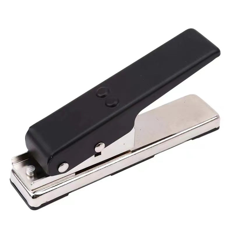 A hand using a Guitar Picks Maker to create personalized guitar picks from a credit card, showing a resulting pick and a leftover piece.