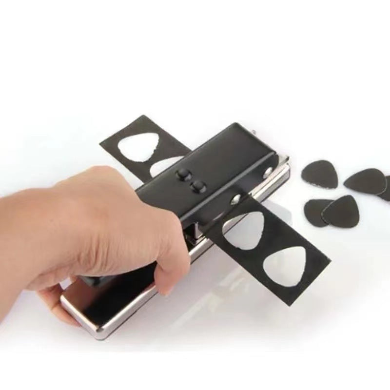 A hand using a Guitar Picks Maker to create personalized guitar picks from a credit card, showing a resulting pick and a leftover piece.