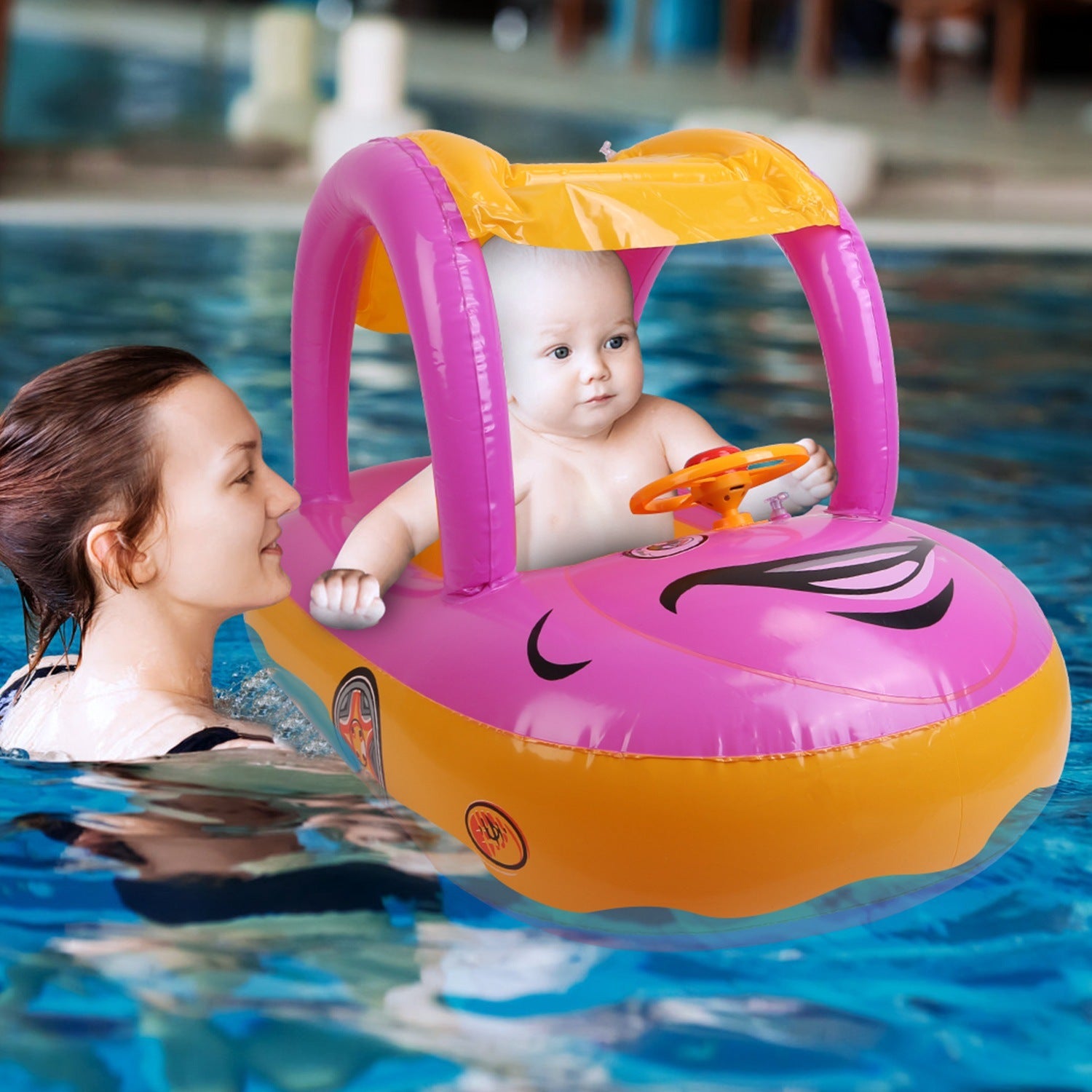 A young child smiles while sitting in a colorful Baby Inflatable Pool Float Car Shaped Toddler Swimming Float Boat Pool Toy Infant Swim Ring Pool with Sun Protection Canopy for 1-3 Year-Old Kids Infant Toddlers in a swimming pool.