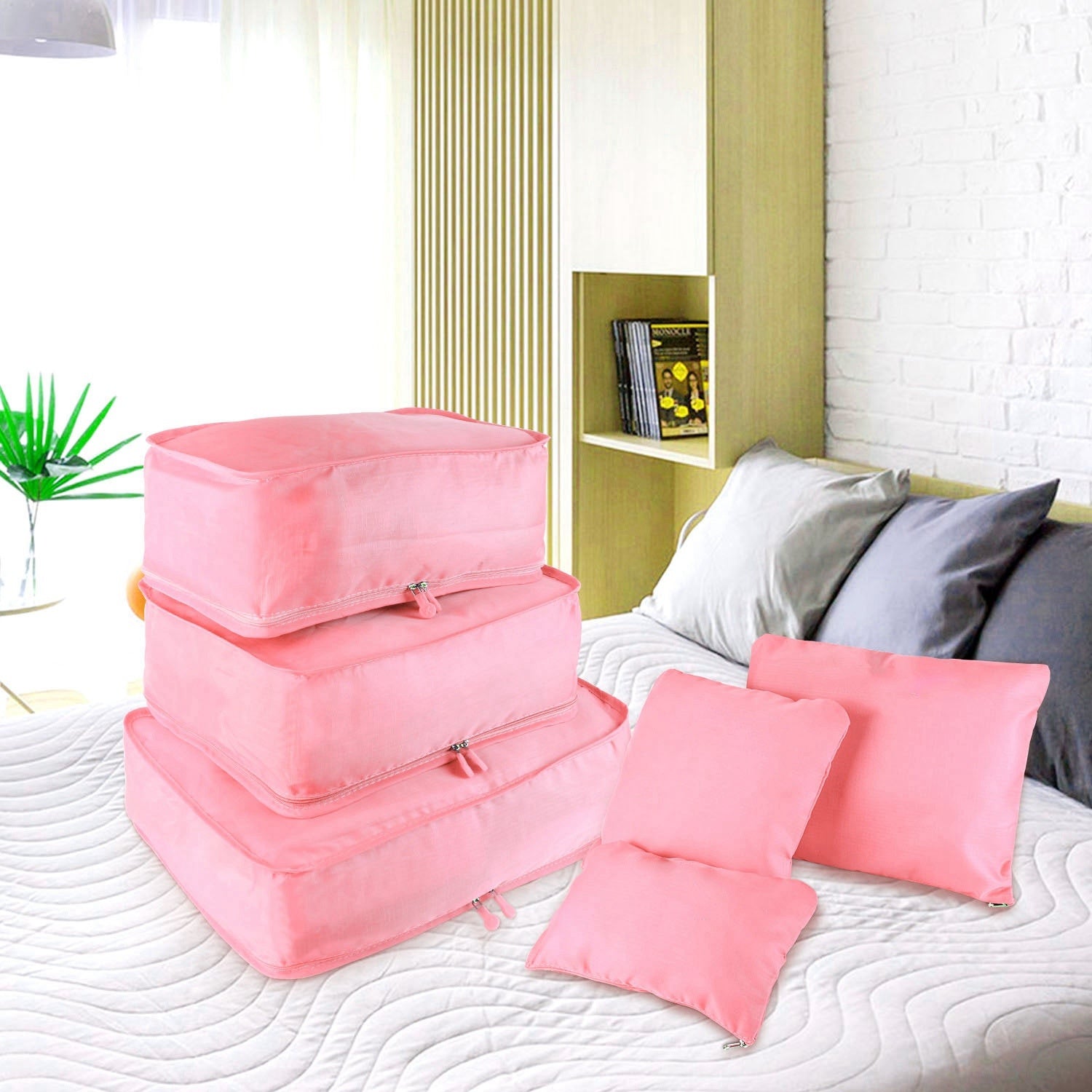 Set of four 9Pcs Clothes Storage Bags Water-Resistant Travel Luggage Organizer Clothing Packing Cubes of varying sizes with clothing items, displayed next to a folded floral blouse, all on a white background.