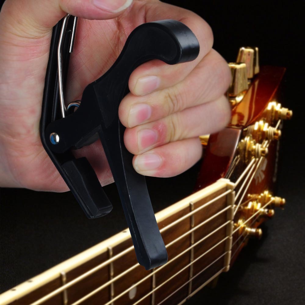 Guitar Capo, easy to operate, isolated on a white background.
