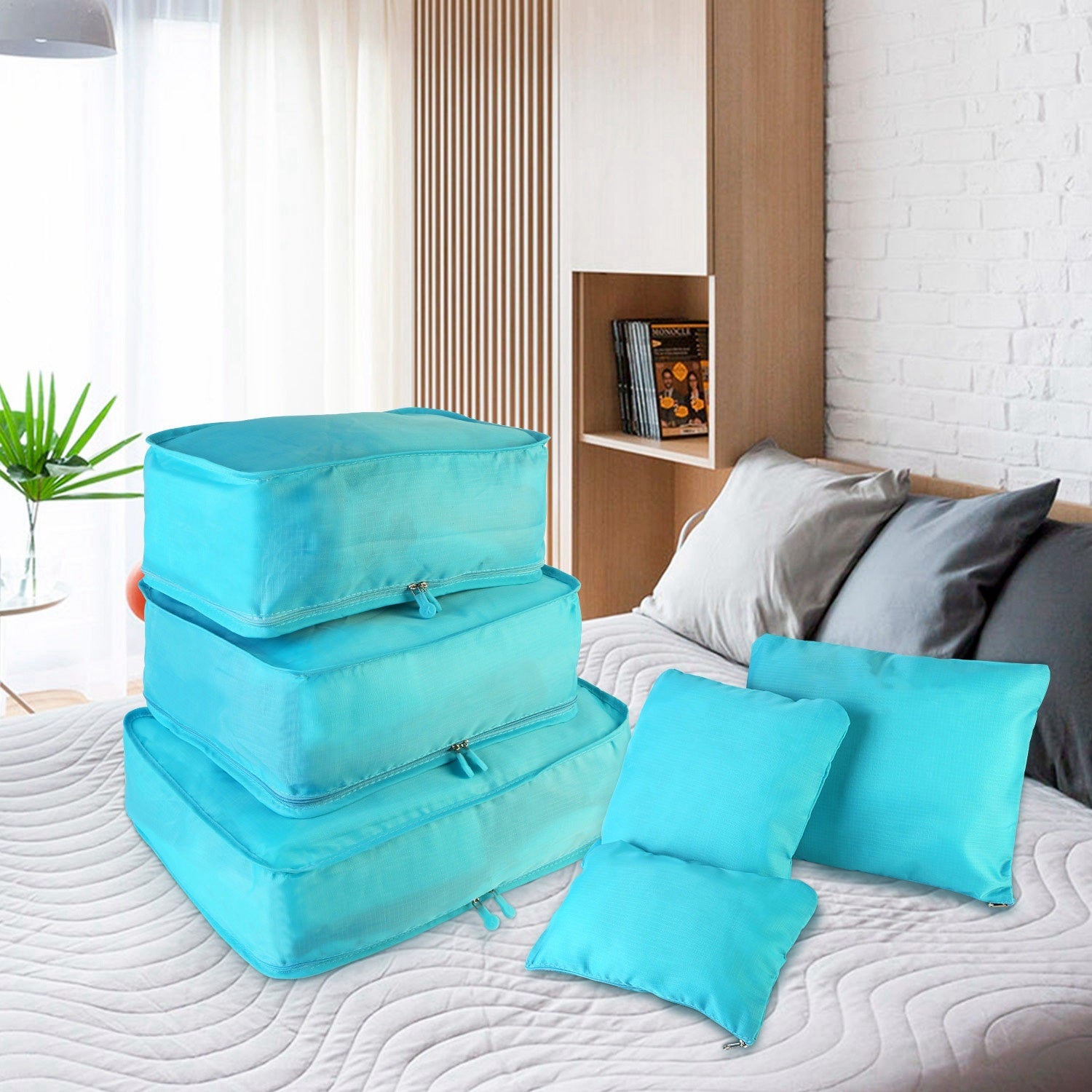 Set of four 9Pcs Clothes Storage Bags Water-Resistant Travel Luggage Organizer Clothing Packing Cubes of varying sizes with clothing items, displayed next to a folded floral blouse, all on a white background.