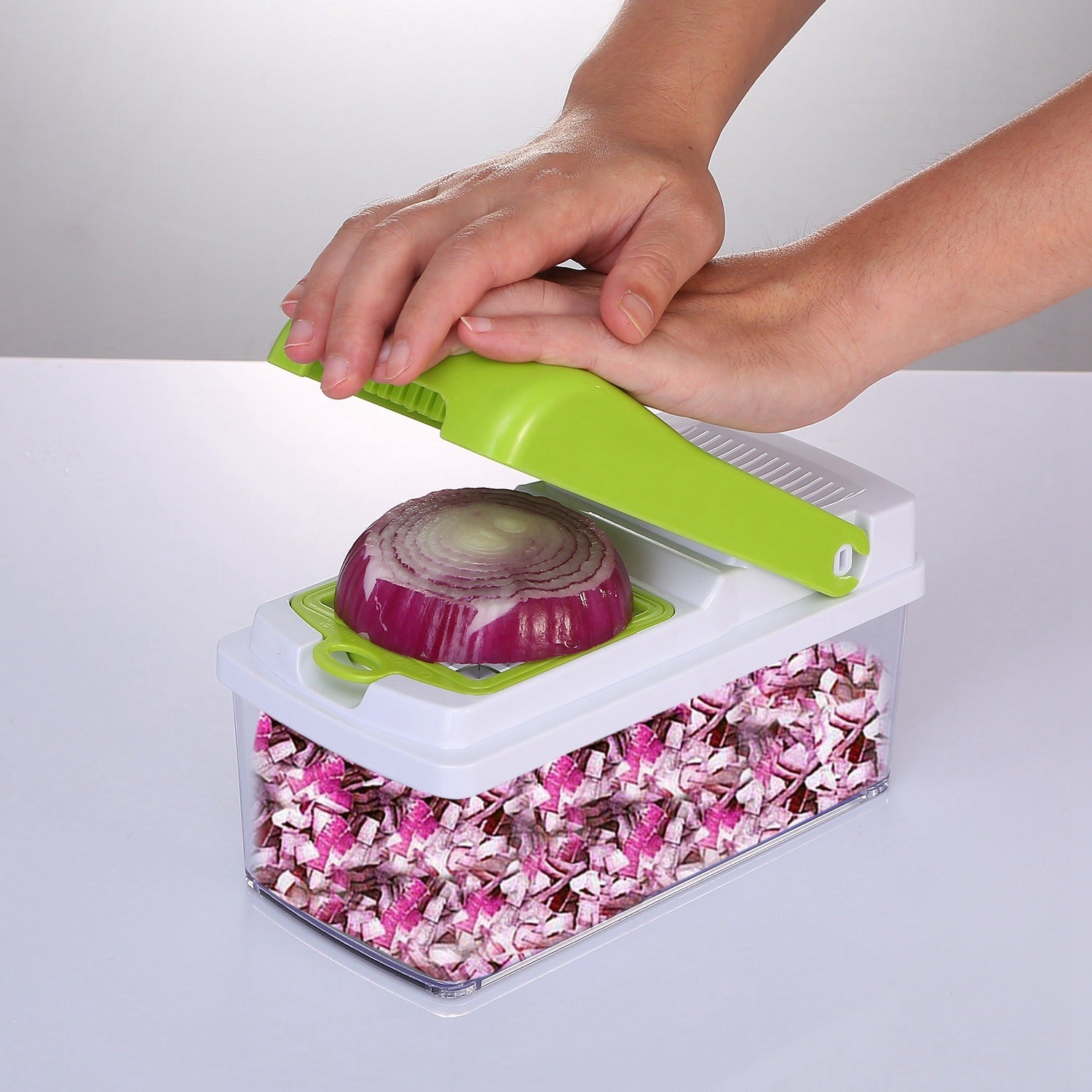 A Vegetable Slicer Quick Potato Tomato Fruit Cutter Set with 3 Blades Stainless Steel Food Chopper with sliced carrots inside it, placed on a kitchen counter with tomatoes nearby.