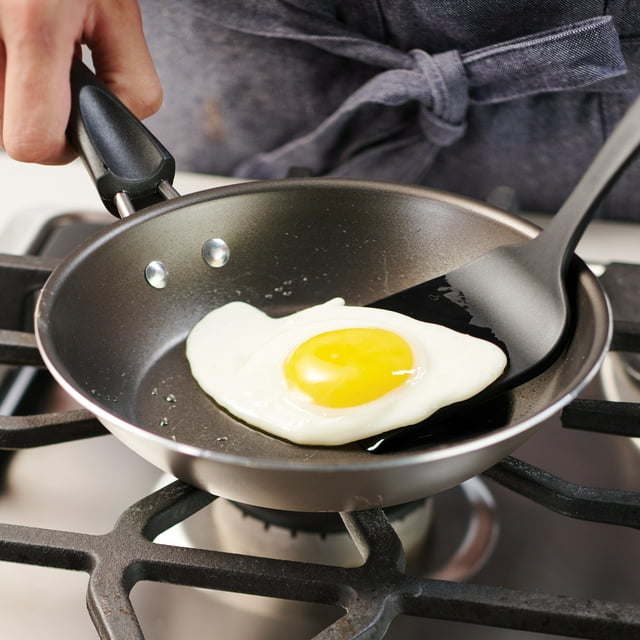 A set of new 9-Piece Non-Stick Cookware Set including two pots, a saucepan, and two frying pans, all with tempered glass lids and black handles, arranged on a white background.