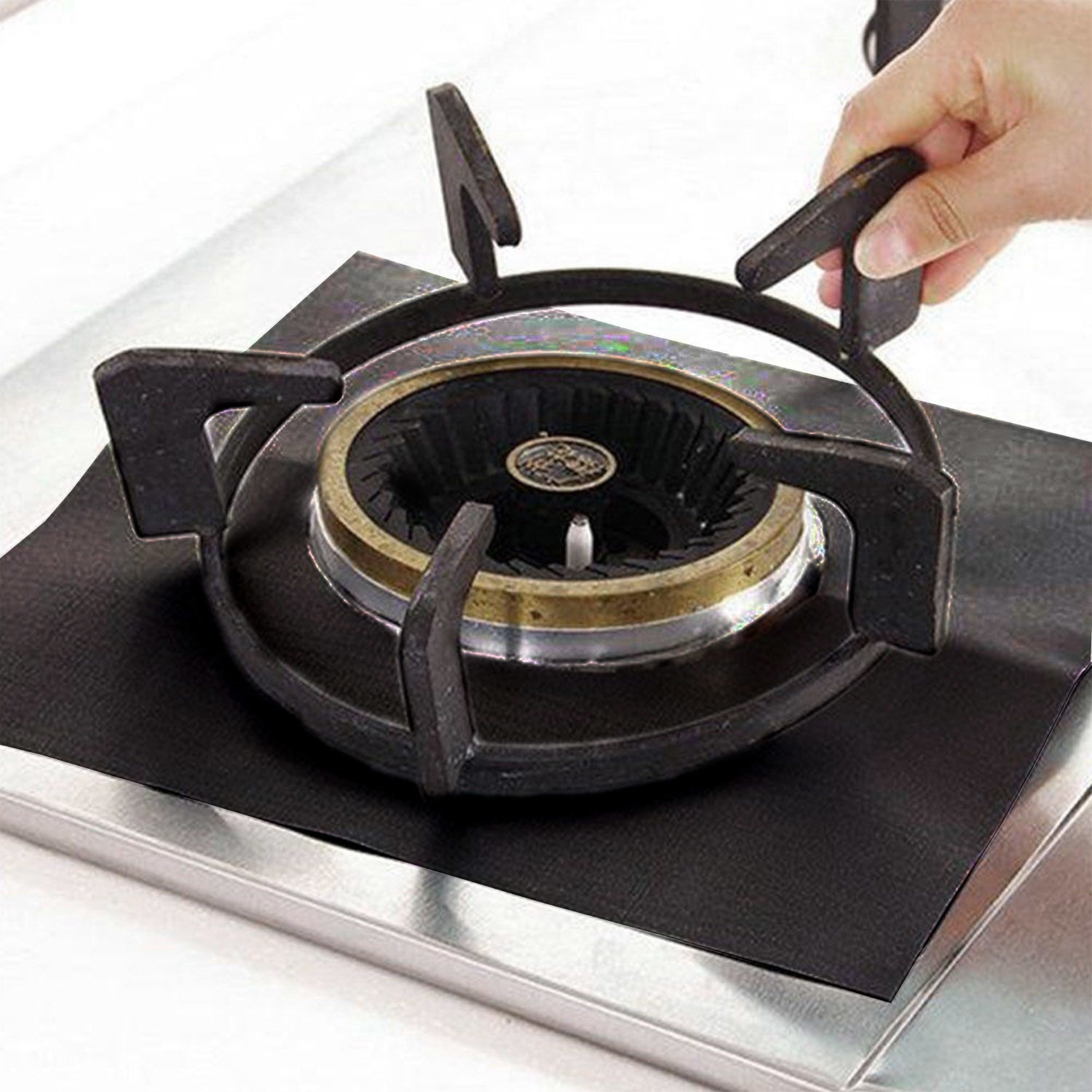 A stack of 4-Pack Reusable Nonstick Stovetop Burner Protector Liner papers with a white circle and crossing lines symbol in the center of the top sheet, treated with a PTFE coating.