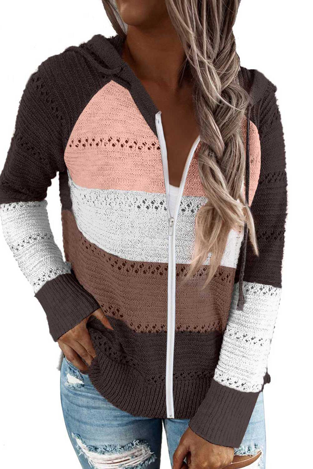 A person wearing the Brown Zipped Front Colorblock Hollow-out Knit Hoodie, featuring a multi-colored striped design with alternating bands of brown, pink, white, and gray. Seen from the back, the sweater showcases the hood and finely knitted texture. The person has long wavy hair—a perfect look for a bonfire on the beach.