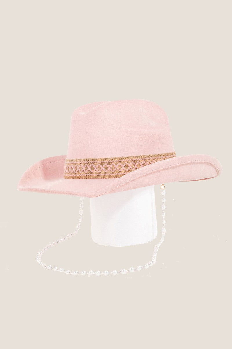 Fame Ornate Band Cowboy Hat in light pink features an intricate band around the crown and a pearl chain elegantly draped from the side, offering a distinctive look.