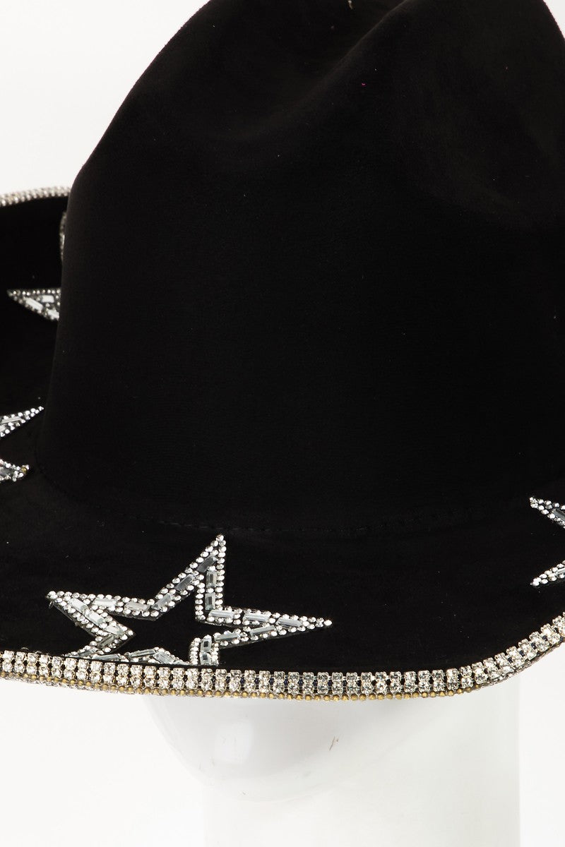 A person wearing the Fame Rhinestone Star Wide Brim Faux Suede Hat looks down against a plain white background.