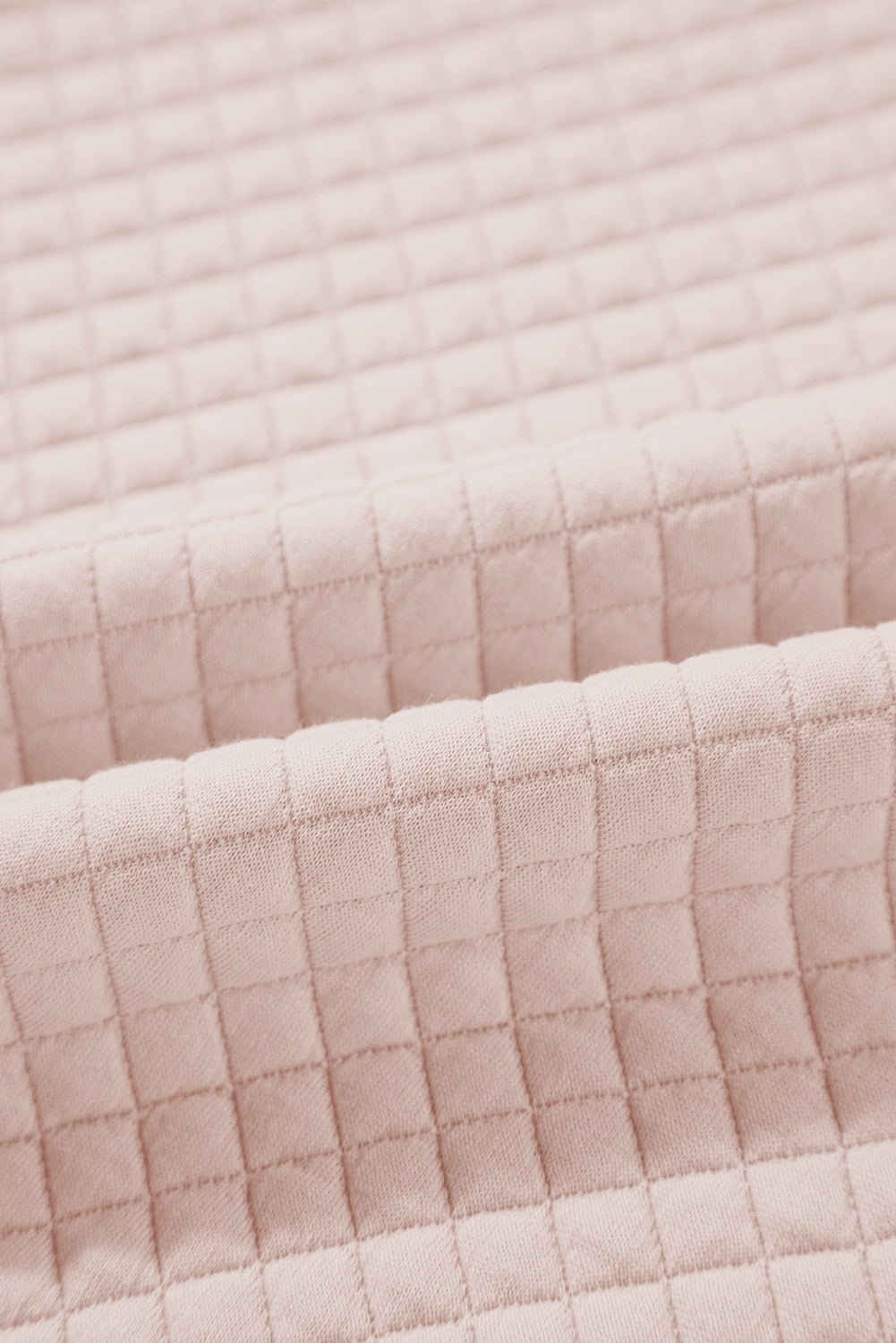 A person wearing an Oatmeal Textured Colorblock Edge Buttoned Collar Sweatshirt, paired with blue jeans, stands with their back to the camera against a white backdrop. The trendy sweatshirt features stylish textured fabric and buttoned collars that add an extra touch of sophistication.