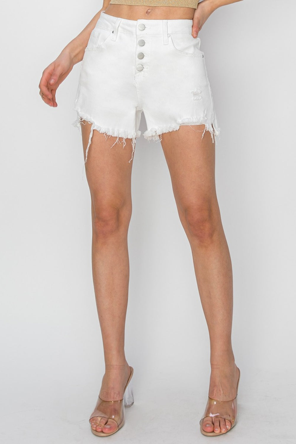 A person wearing RISEN Button Fly Frayed Hem Denim Shorts, showcasing a casual summer look.