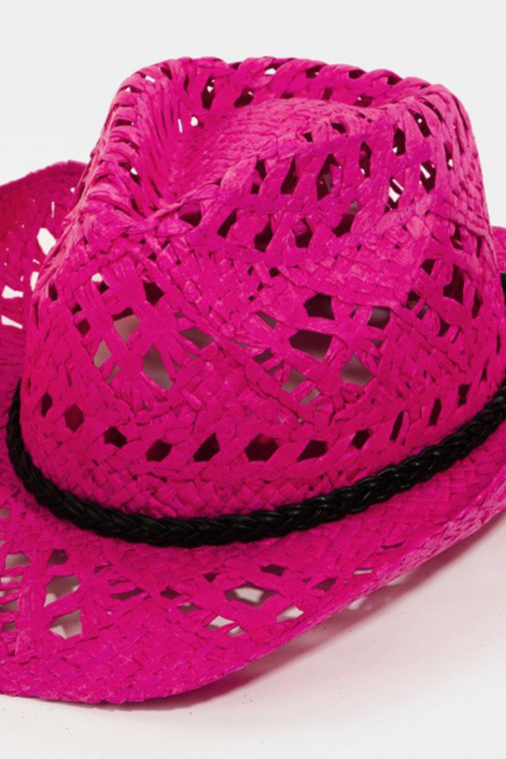 The Fame Cutout Wide Brim Hat is a stylish accessory featuring a pink woven design, complete with a black band and textured pattern. Its wide brim provides excellent sun protection, making it the perfect combination of style and function.