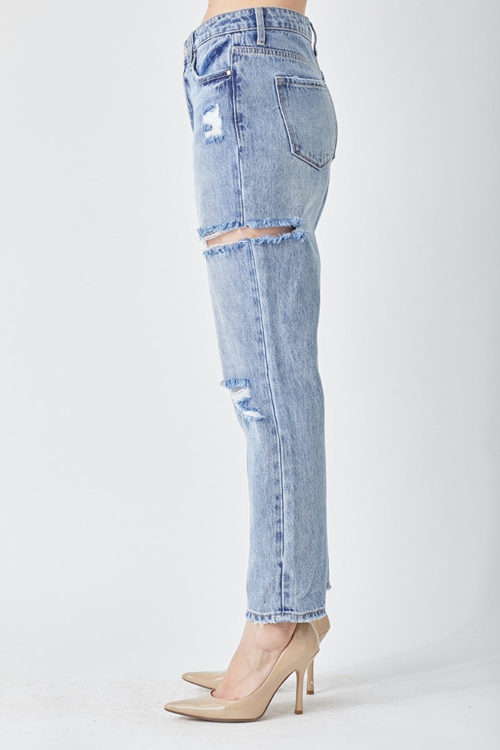 Person wearing the RISEN Distressed Slim Cropped Jeans and beige high heels stands against a plain white background.