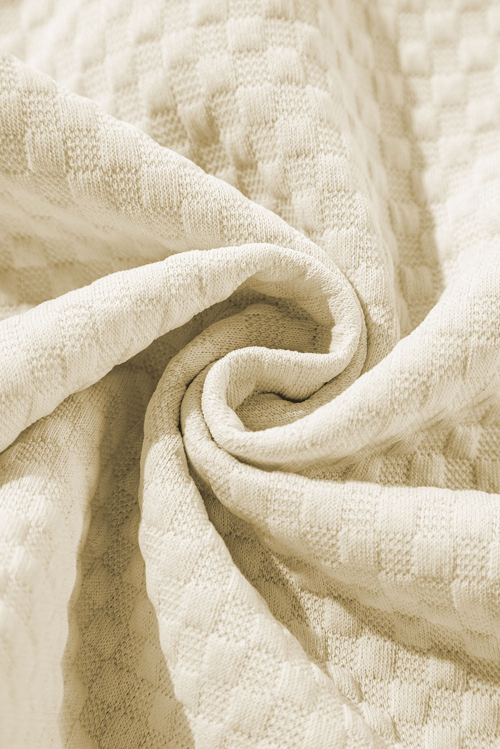 A person stands indoors facing away, wearing the Apricot Textured Buttoned Neckline Side Pockets Hoodie and black shorts. Their hand rests on their hip.