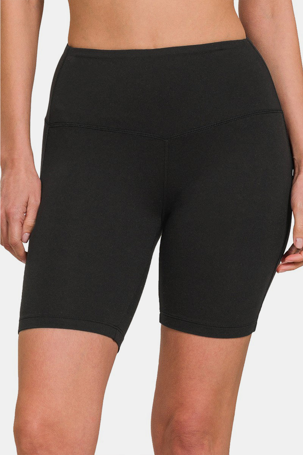 Close-up of a person wearing Zenana High Waist Active Shorts in black, designed with moisture-wicking fabric. The background is plain white.