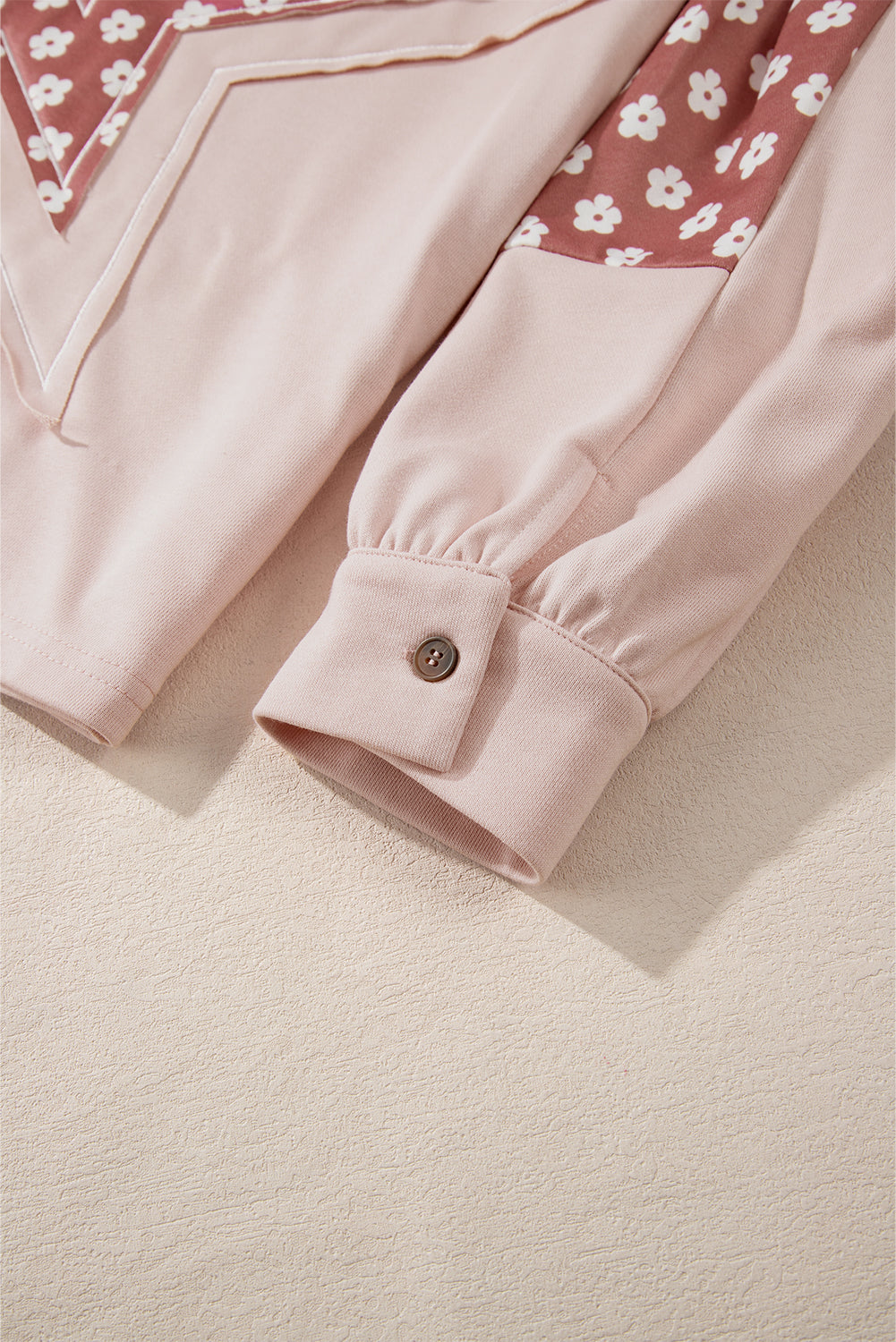 Person wearing the Delicacy Floral Patchwork Star Pattern Drawstring Hoodie, showcasing the floral patchwork design on the hood and sleeves from the back.