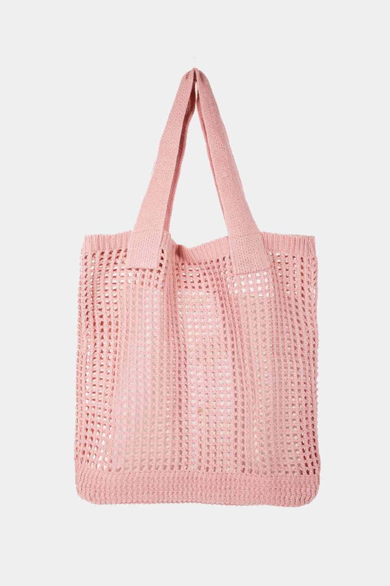 The Fame Pointelle Knit Crochet Tote Bag, available in a trendy light pink color, boasts a stylish open mesh pattern and two parallel shoulder straps, making it the perfect accessory for modern fashion.