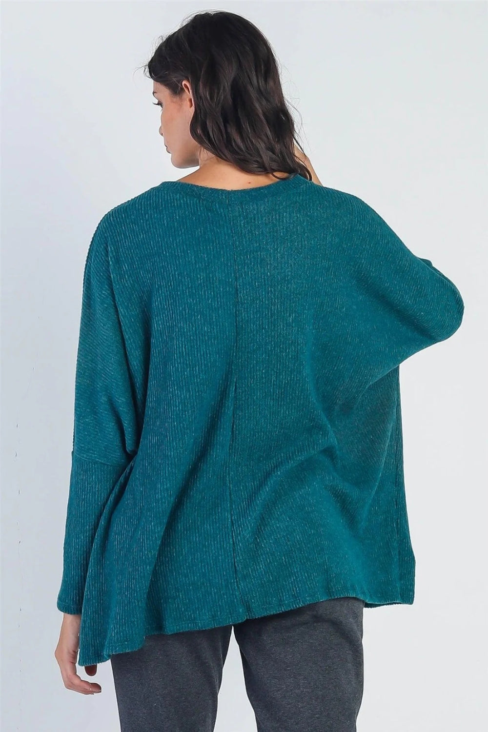 A person stands in front of a plain background wearing the Cherish Apparel Round Neck Long Sleeve Sweater in teal, dark gray pants, white socks, and beige slide sandals—a classic wardrobe staple.