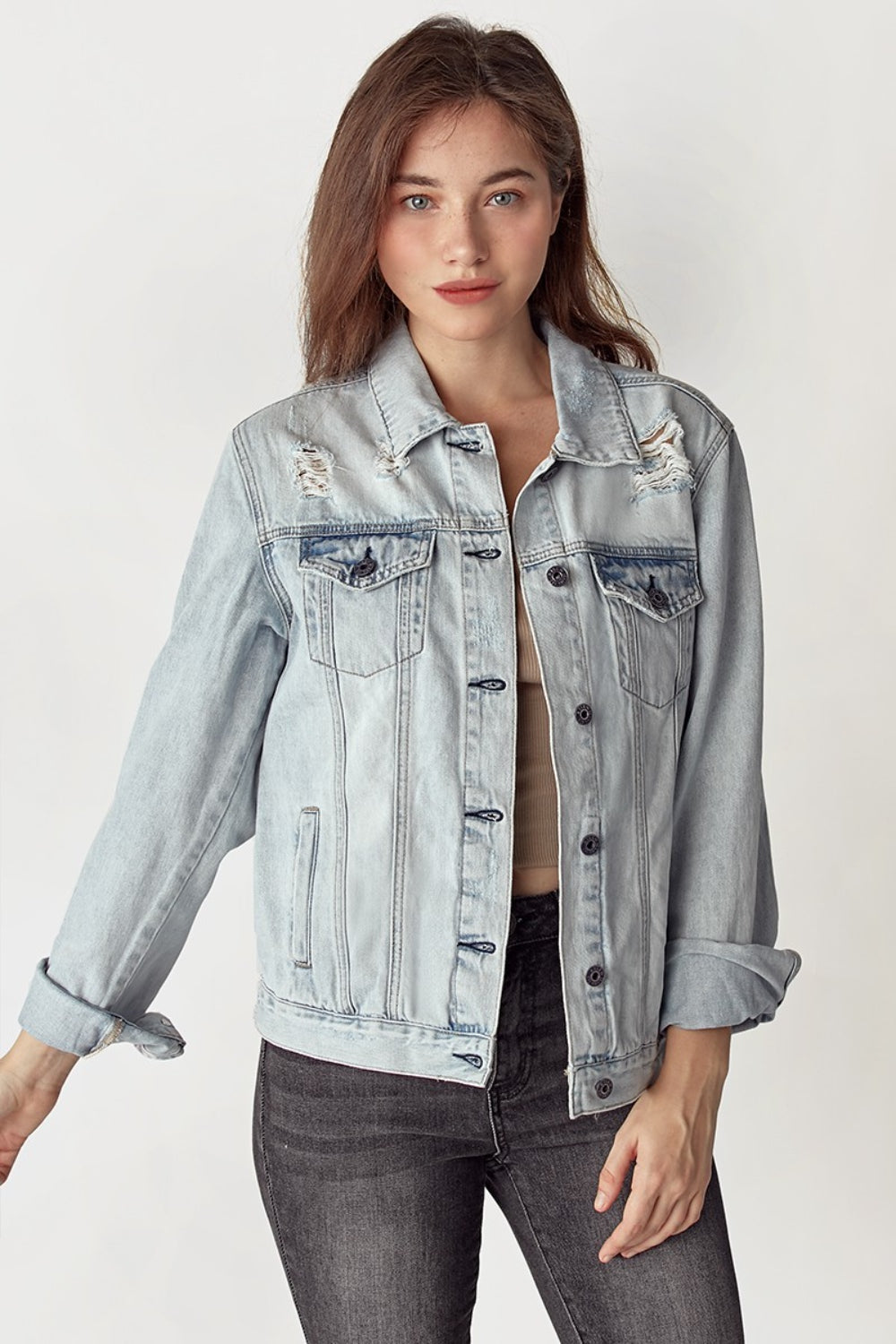 A person wearing the RISEN Distressed Button-Up Jacket with rolled-up sleeves, posing against a plain background.