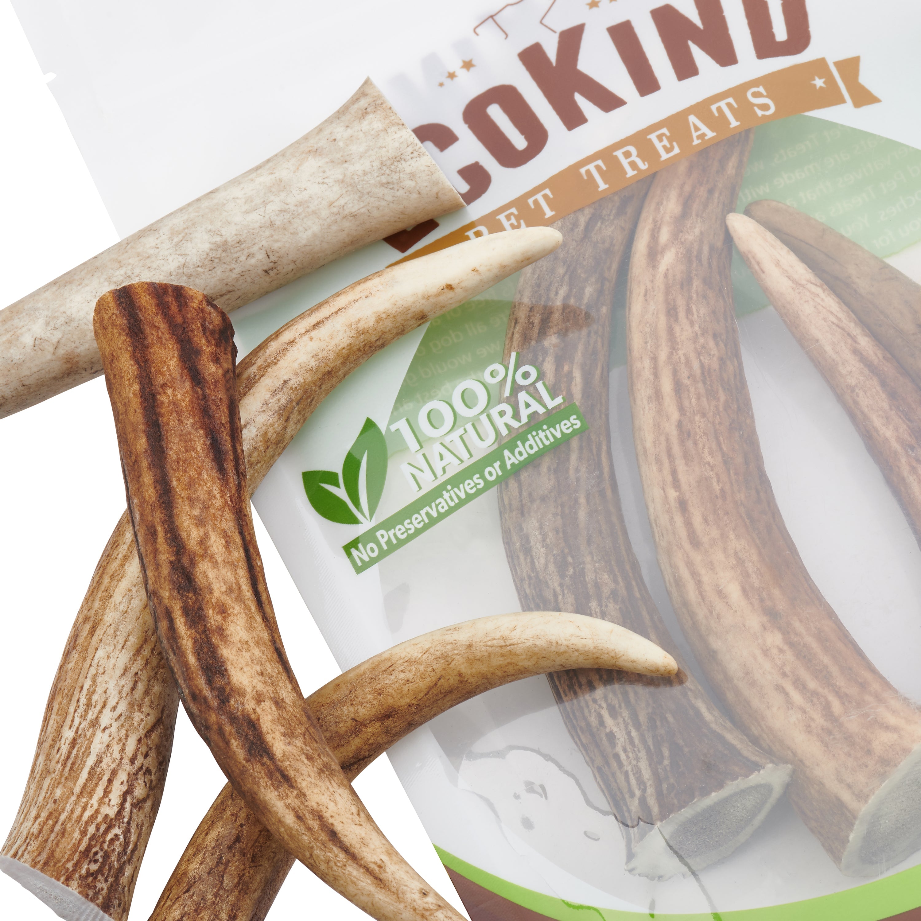 The packaging for Elk Antler Tips Dog Chews, proudly labeled "100% natural," displays a cheerful dog and highlights four Natural Dog Chews crafted from Elk Antler Tips. These chews are perfect for boosting dental health while providing a delightful treat for your beloved pet.