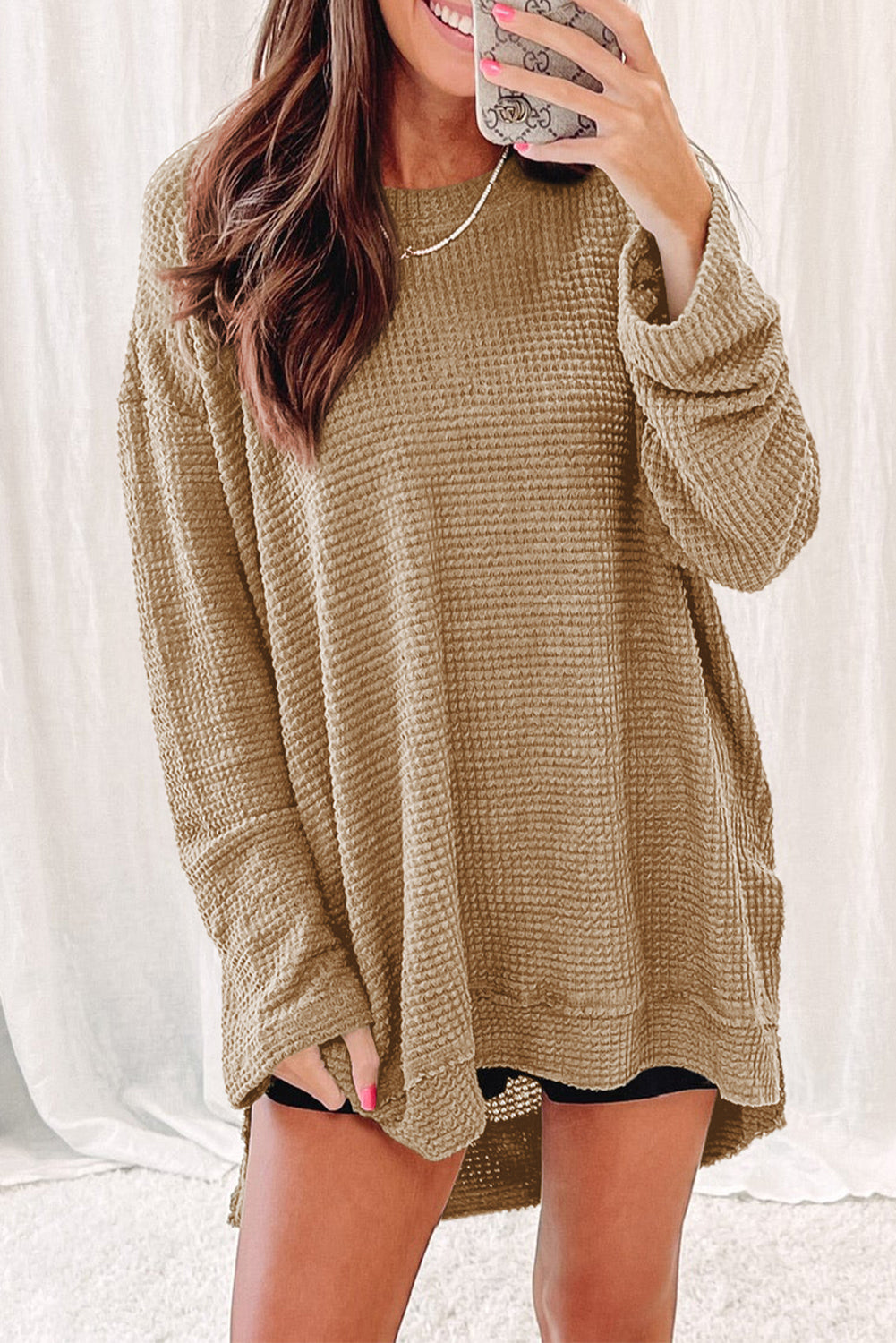 Person wearing a trendy Green Waffle Knit Drop Sleeve High Slits Oversized Top takes a mirror selfie, showcasing the cozy waffle knit texture along with their upper and part of their lower body.