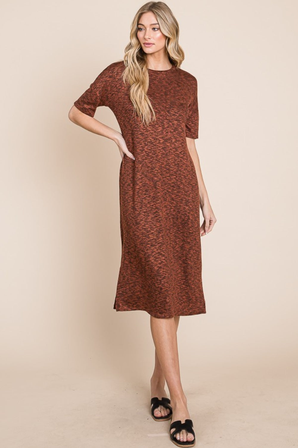 A person with long, wavy hair wearing the BOMBOM Round Neck Side Slit Midi Dress in brown and black sandals stands against a plain background.