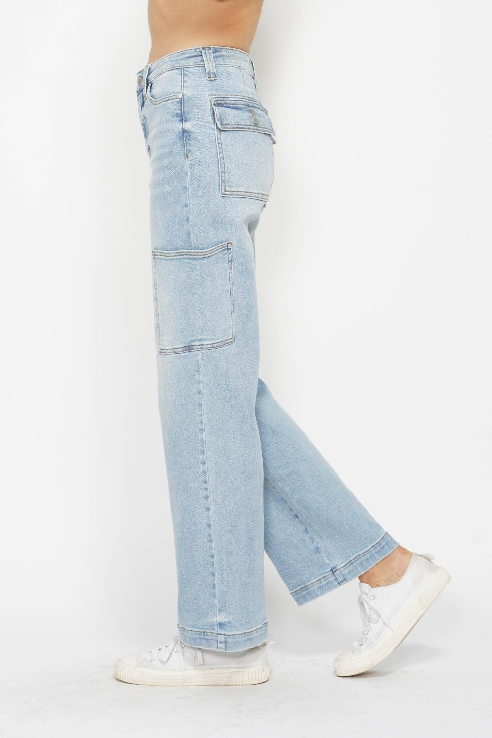 Person wearing Judy Blue Full Size High Waist Straight Cargo Jeans in light blue with white sneakers against a white background, showcasing a utility style.