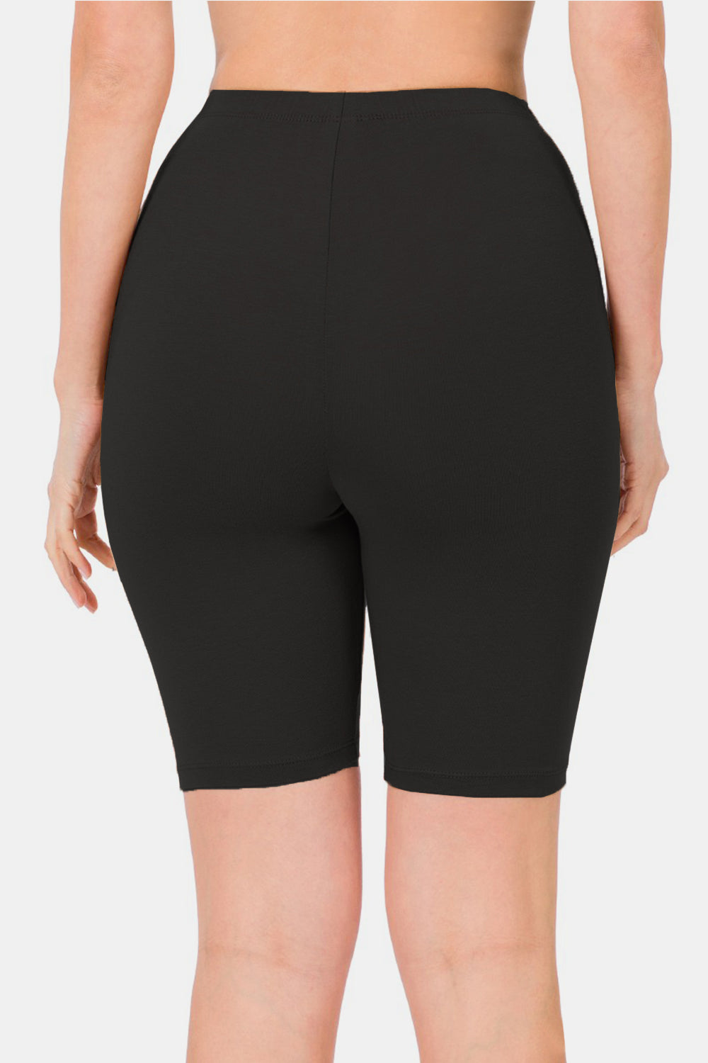 A person modeling the fashionable Zenana High Waist Biker Shorts in sleek black against a plain white background. The activewear shorts extend to mid-thigh, showcasing the upper legs and a small section of the torso.