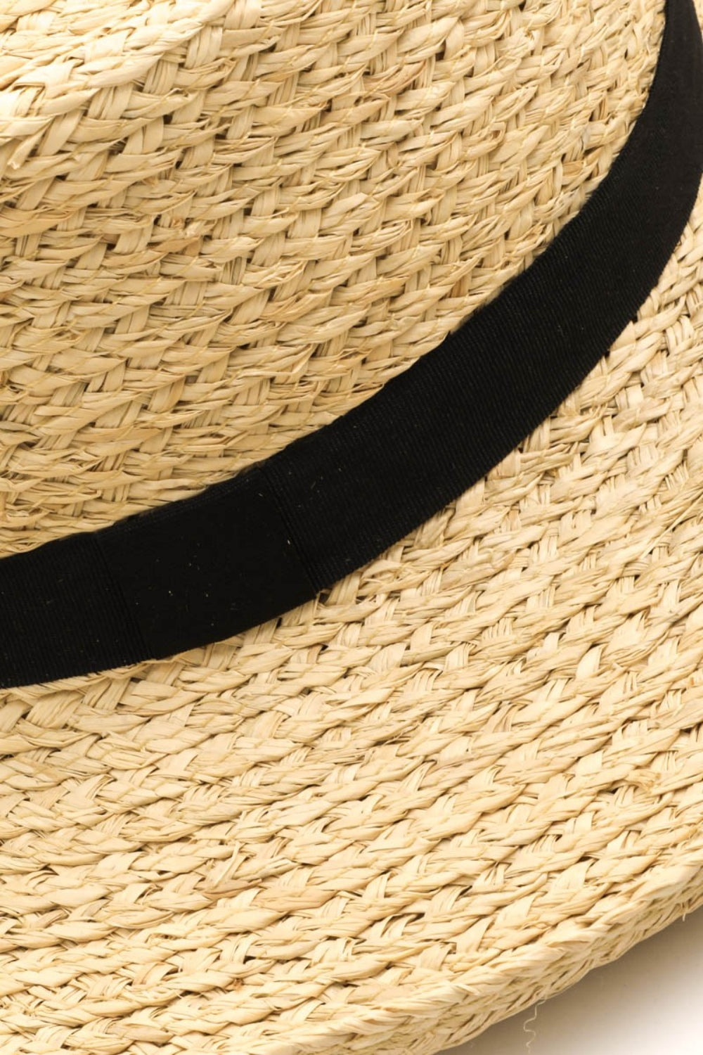 A person smiling in a Fame Wide Brim Straw Weave Hat and a white tank top epitomizes the ideal summer wardrobe against a light background.