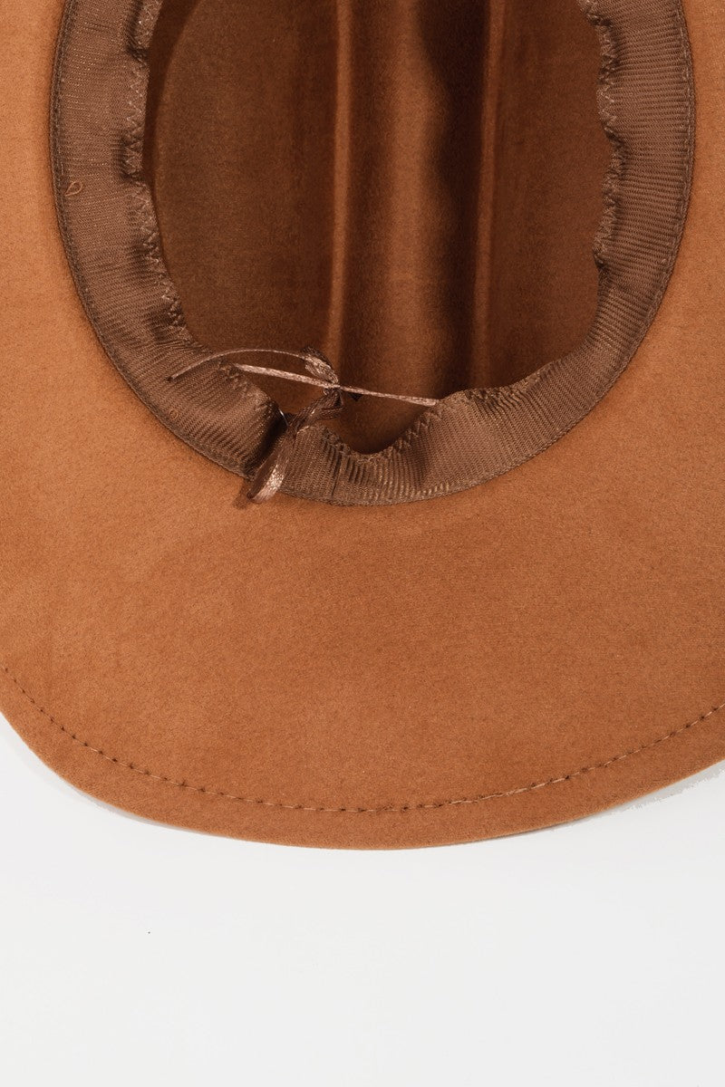 The Fame Solid Wide Brim Hat, showcasing a classic western style with its wide brim and creased crown, sits elegantly on a white surface.