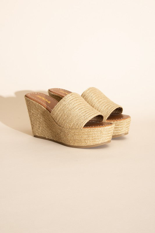 A pair of Bounty-S Wedge Platform Heels featuring a beige woven straw-like texture, open toe straps, and brown insoles.