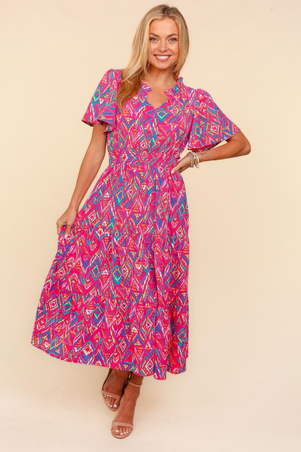 Person wearing the Haptics Abstract Print Smocked Waist Dress with Pockets, smiling with one hand on hip, exuding confidence and style.