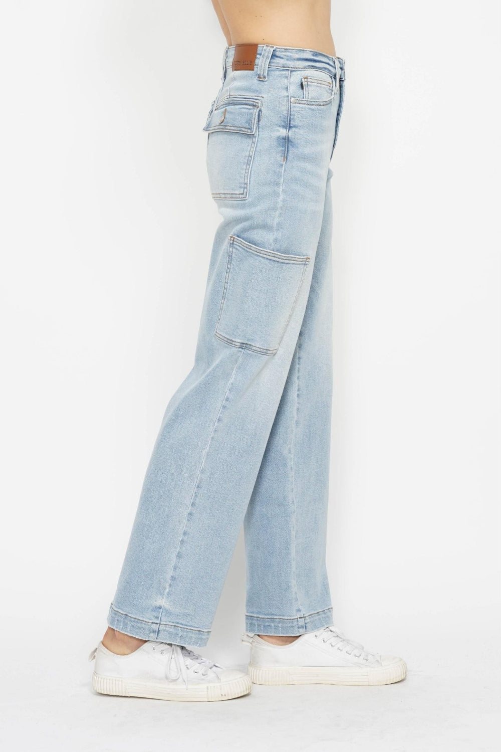 Person wearing Judy Blue Full Size High Waist Straight Cargo Jeans in light blue with white sneakers against a white background, showcasing a utility style.