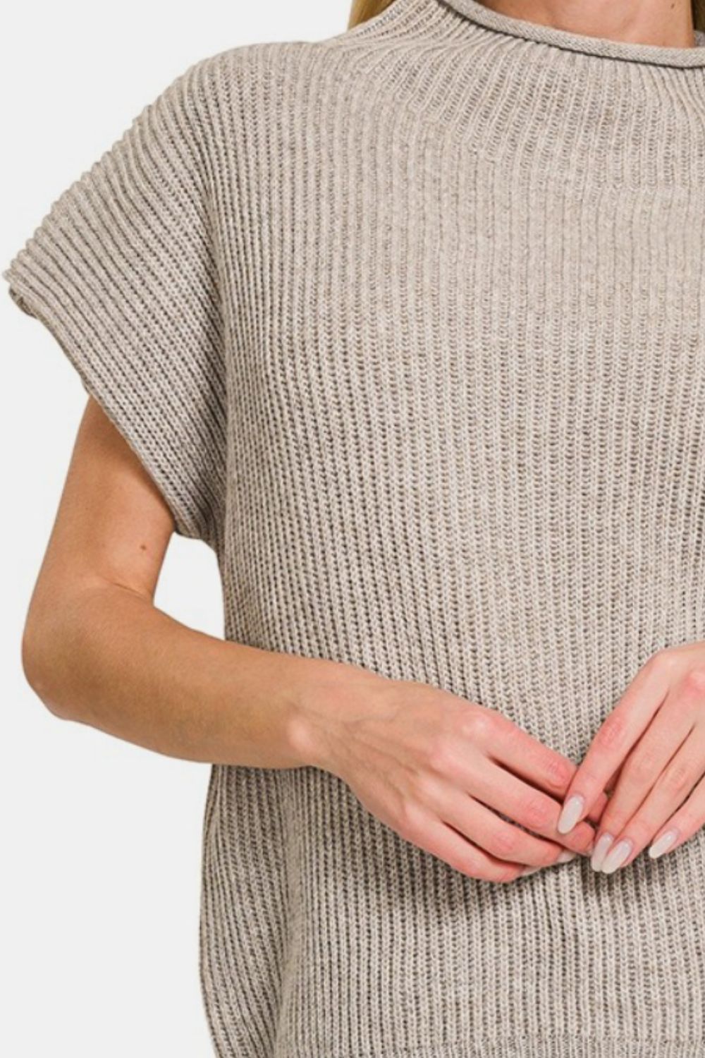 Person wearing a Zenana Short Sleeve Mock Neck Sweater in gray with jeans, standing against a plain background.