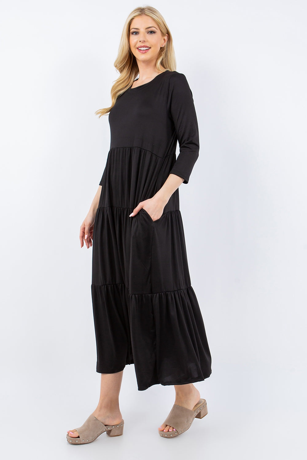 A person wearing the Celeste Full Size Tiered Midi Dress with pockets stands against a neutral background.