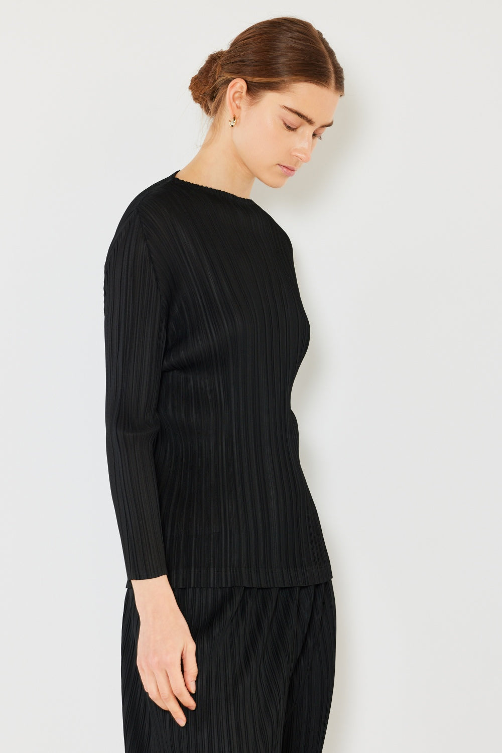 A person wearing the Marina West Swim Pleated Long Sleeve Boatneck Top with matching pants stands against a plain background.