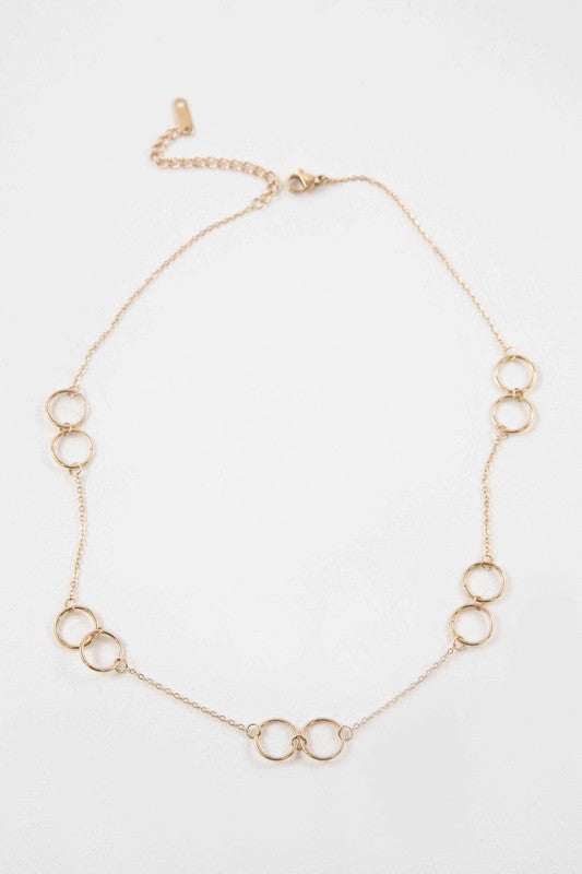 The Double Double Necklace is adorned with interlinked circular designs made from 14k gold-plated stainless steel and fastens with a lobster clasp.