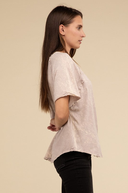 A person with long brown hair wearing a Back Patch Crinkle Washed Raglan Sleeve T-Shirt stands against a plain beige background.