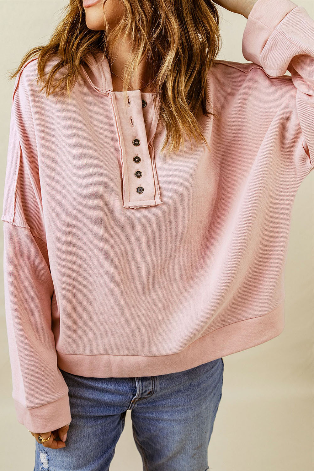 Person with wavy hair wearing a Pink Casual Button Solid Patchwork Trim Hoodie and blue jeans, photographed from the back against a plain background, showcasing fall and winter comfortableness.