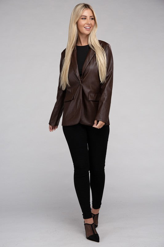 A person with long blonde hair wears the Sleek Pu Leather Blazer with Front Closure over a black top, standing against a plain background.