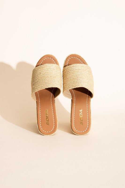 A pair of Bounty-S Wedge Platform Heels featuring a beige woven straw-like texture, open toe straps, and brown insoles.