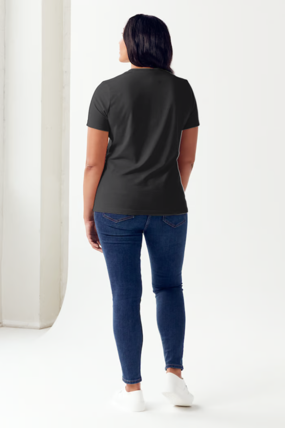 A person wearing a black Simply Love Full Size SPOOKY CLUB Short Sleeve Tubular T-Shirt featuring an illustration of a skeletal hand on the front, made from ringspun combed cotton for ultimate comfort.