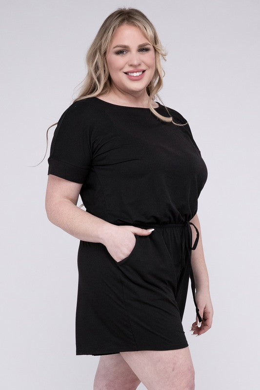 A person is wearing the Plus Brushed DTY Romper with Pockets in bright pink, smiling as they pose with one hand on their head and the other tucked into a pocket, all set against a gray background.