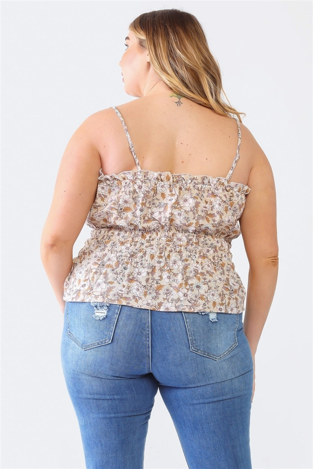 A person with long hair, wearing the Zenobia Plus Size Frill Floral Square Neck Cami and dark jeans, stands with one hand on their hip and the other relaxed by their side.