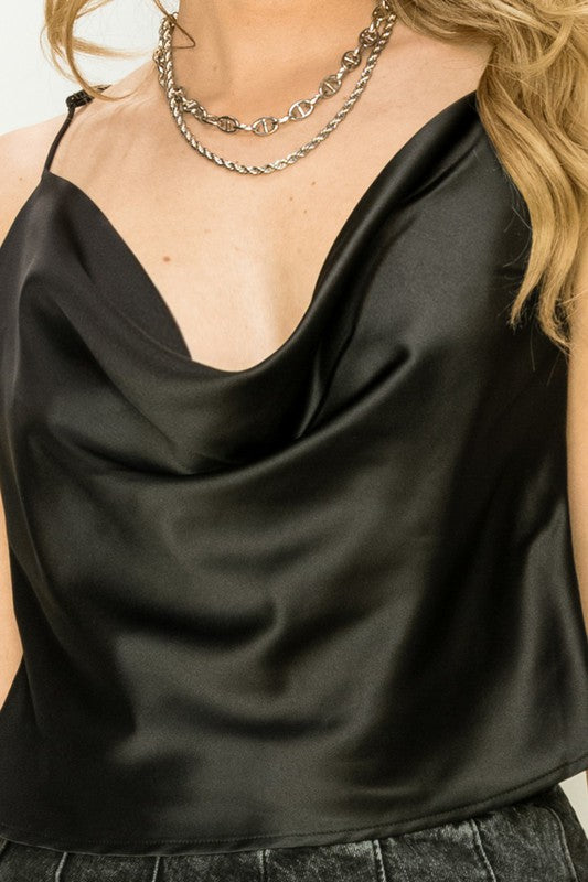 Individual dressed in a Love Forever Cowl Neck Camisole Top and a layered necklace, positioned against a light background.