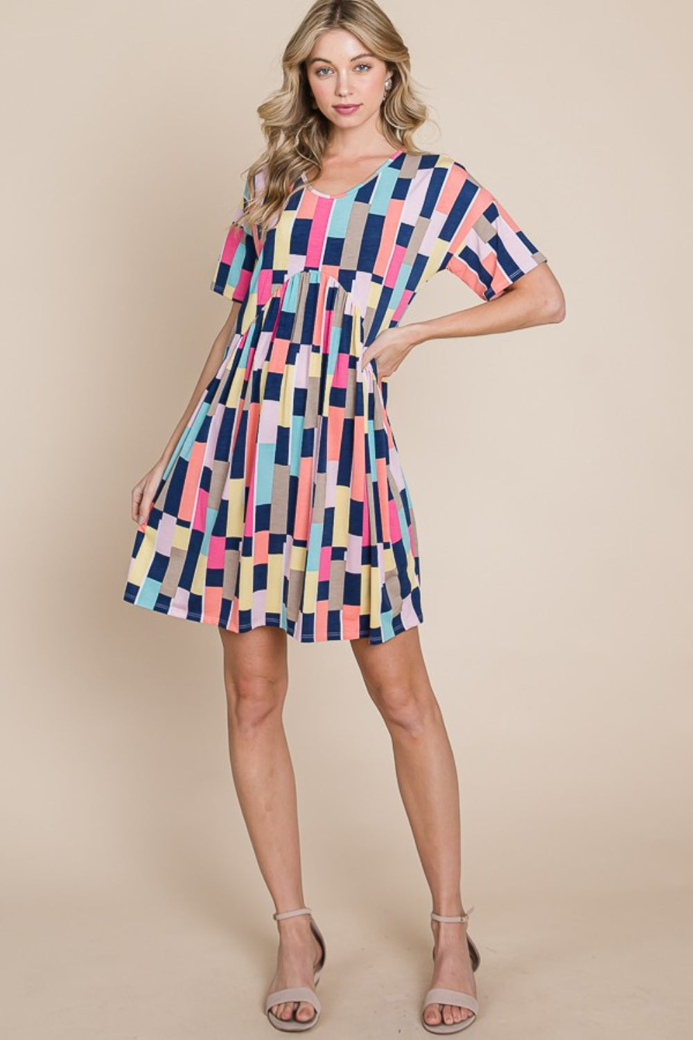 Person wearing the BOMBOM Ruched Color Block Short Sleeve Mini Dress and a straw hat, standing against a beige background, smiling.