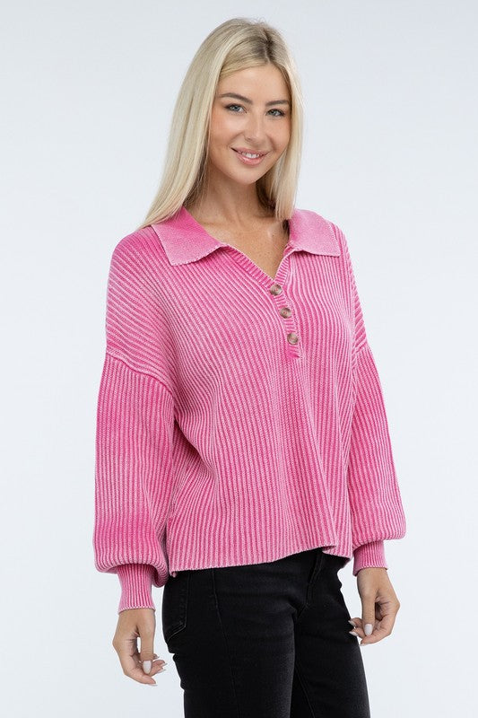 A woman with long blonde hair is wearing the Washed Collared Henley Sweater in pink and black pants, smiling at the camera.