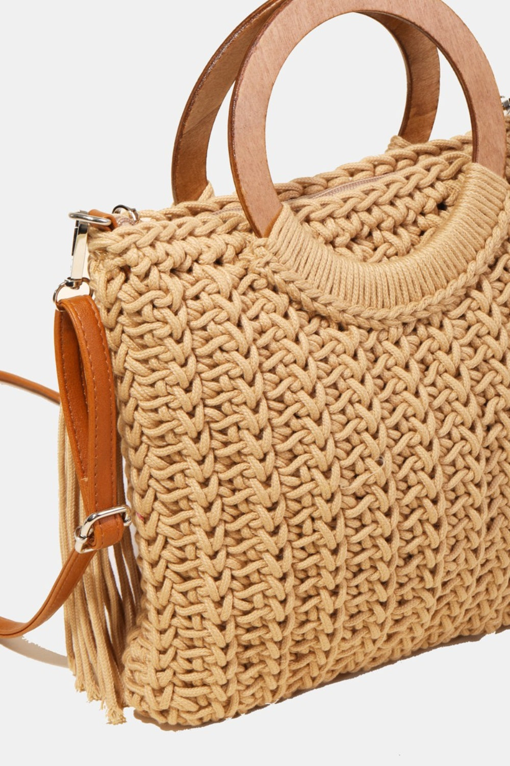 The Fame Crochet Knit Convertible Tote Bag includes a cream-colored design with round wooden handles and a matching tassel accent.